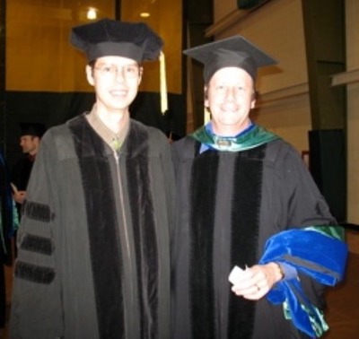 Photo of Philip Riggs Ph.D. graduation with advisor Dr. Denis Dean.
